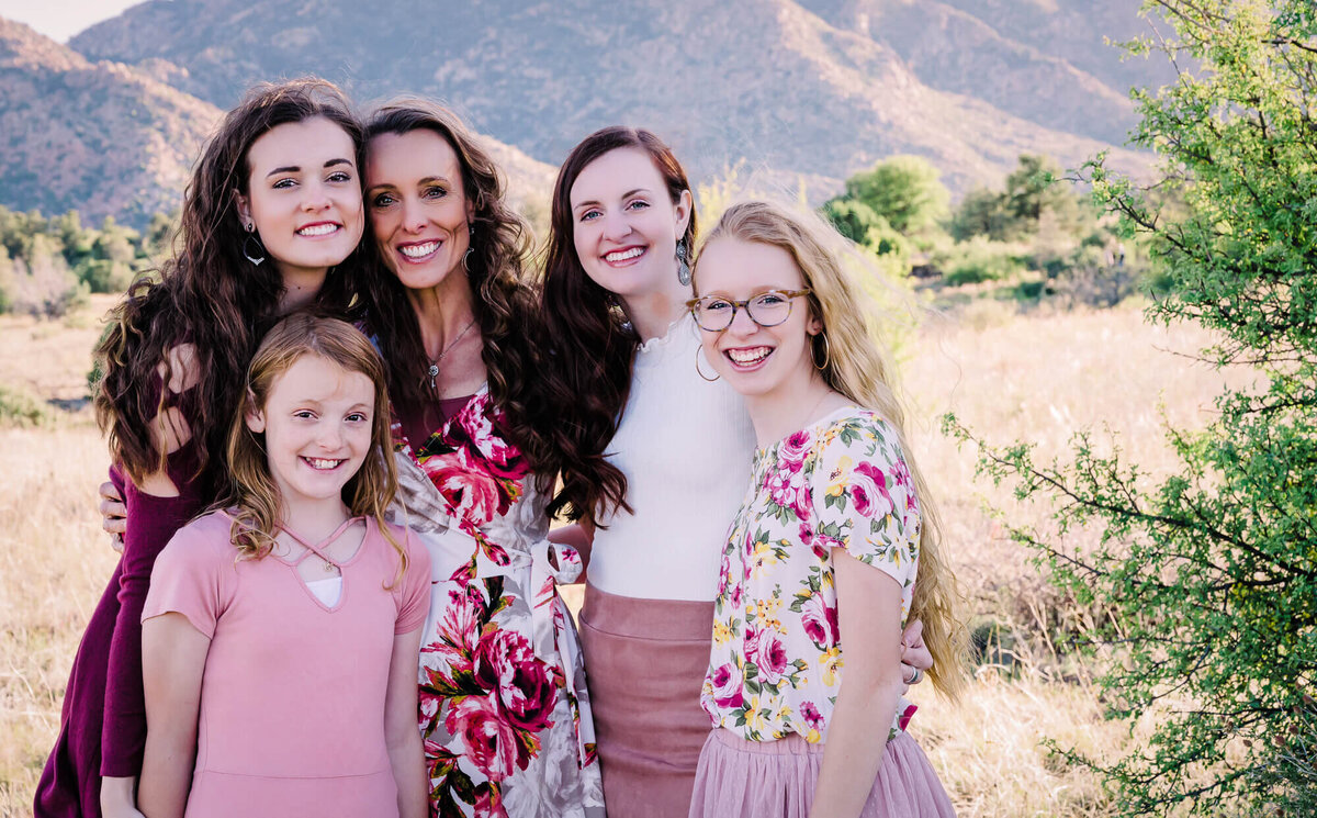 Mom poses with daughters in front of Granite Mountain for Prescott family photographer Melissa Byrne