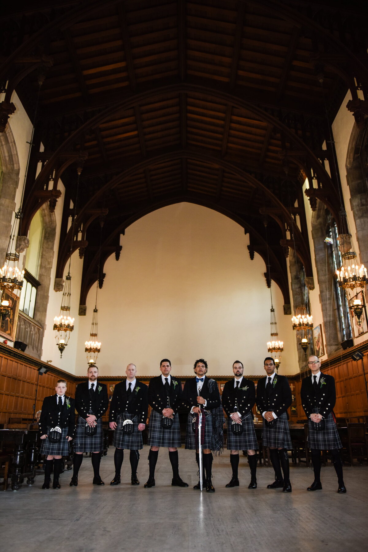Groom and Groomsmen Posing in Traditional Kilts 