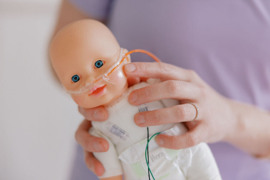 Baby doll with tubes and hospital clothing