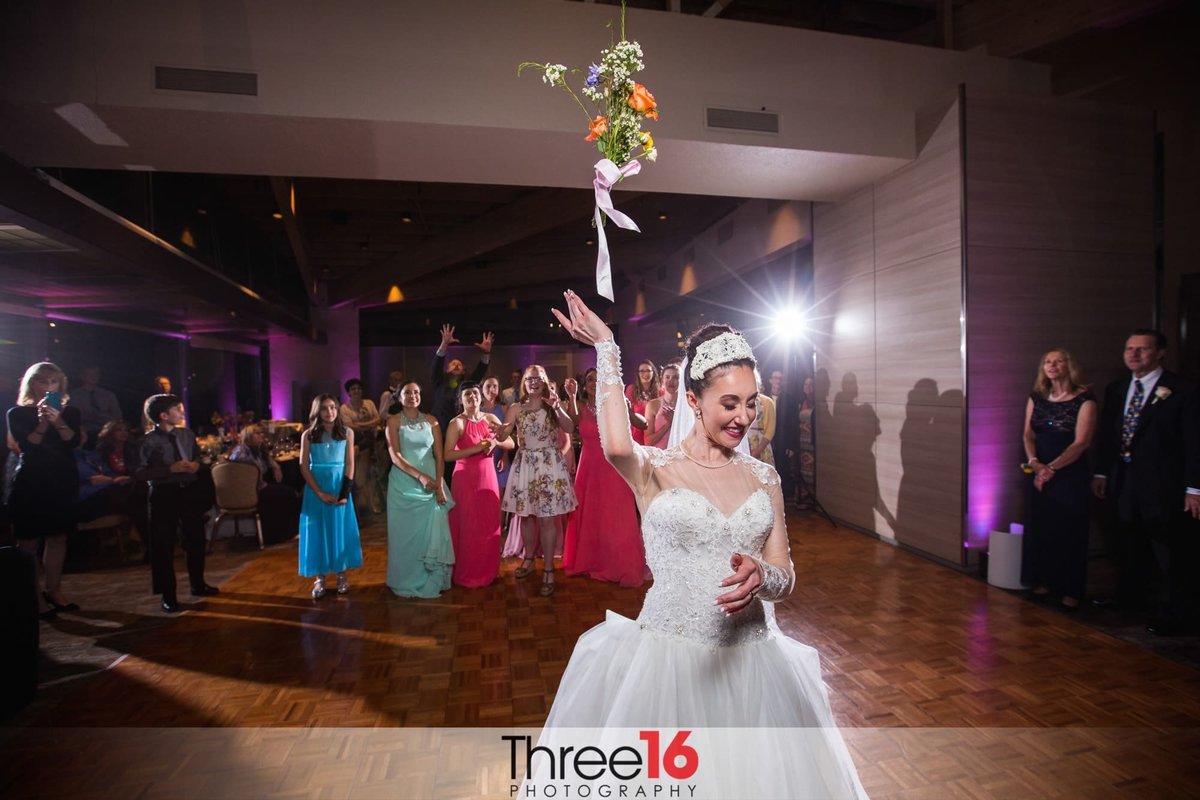 Bride tosses her bouquet to the single ladies