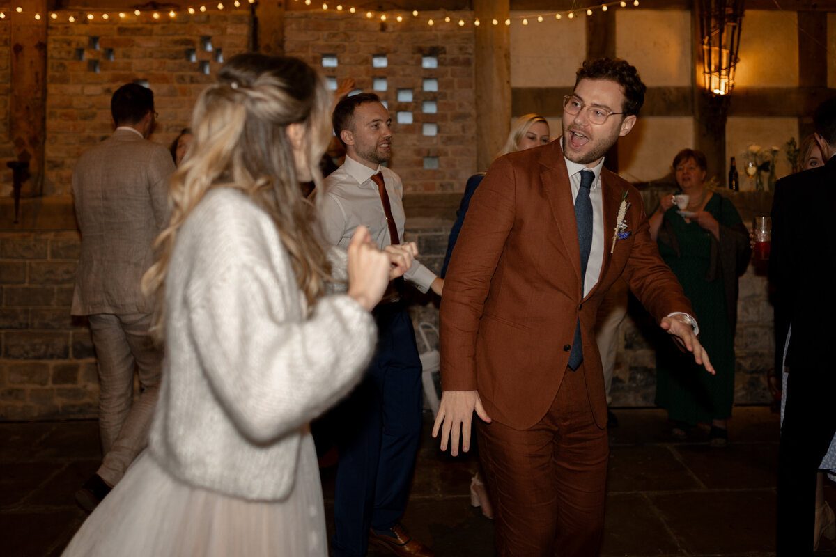 The bride and groom dance  in the Wool Barn at Frampton Court Estate, Gloucestershire