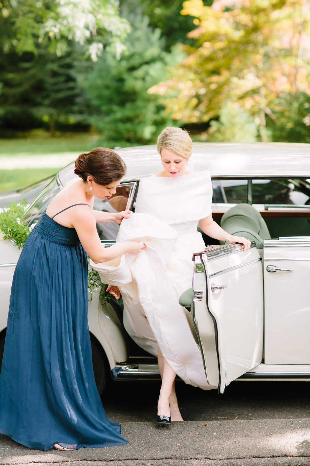 Bride exiting vintage car