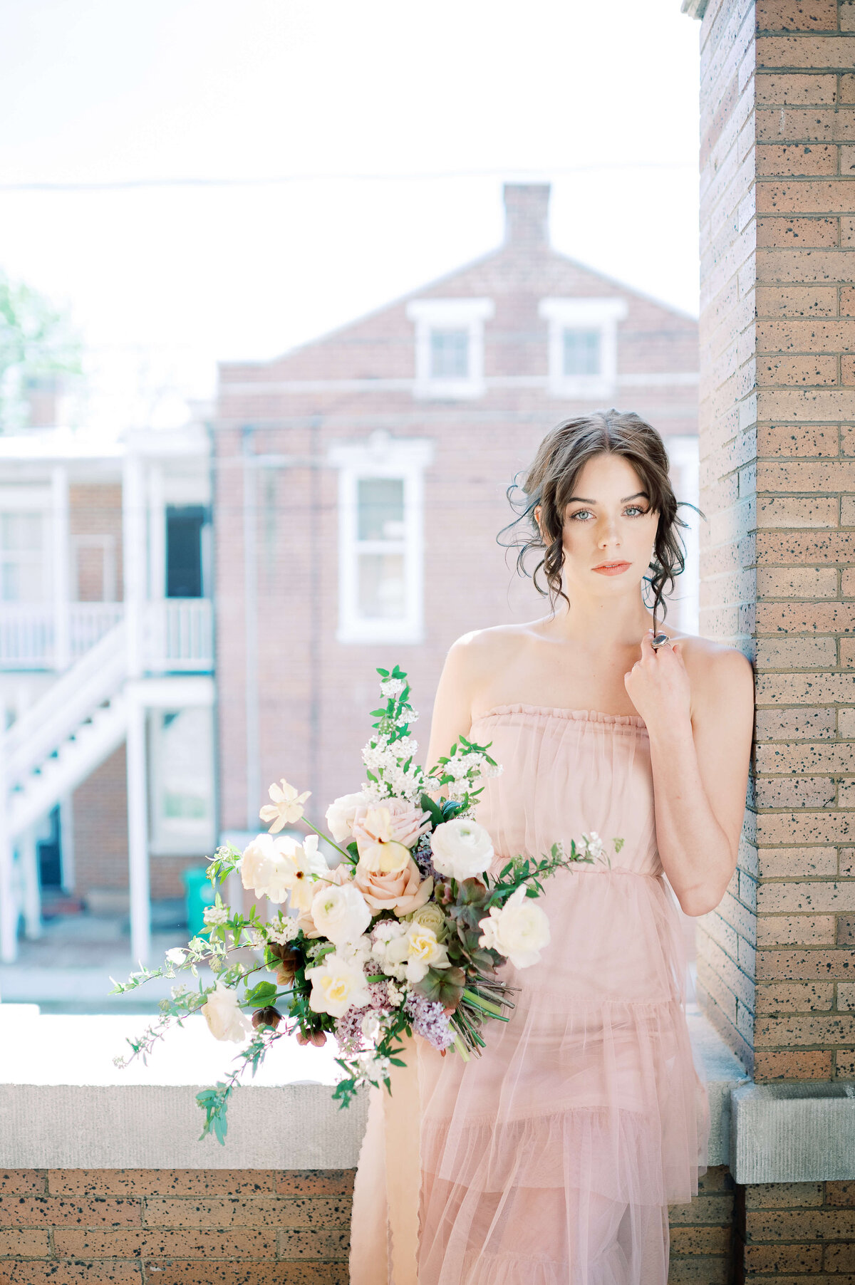 bride in tulle dress holding a large bouquet