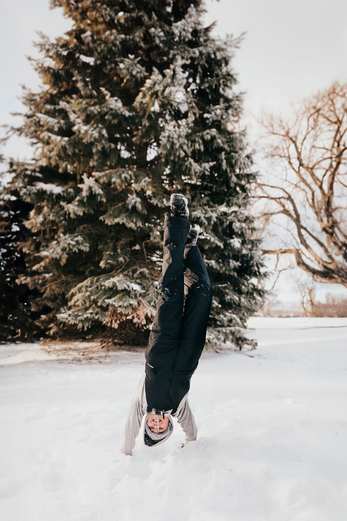 boy-doing-headstand-in-snow
