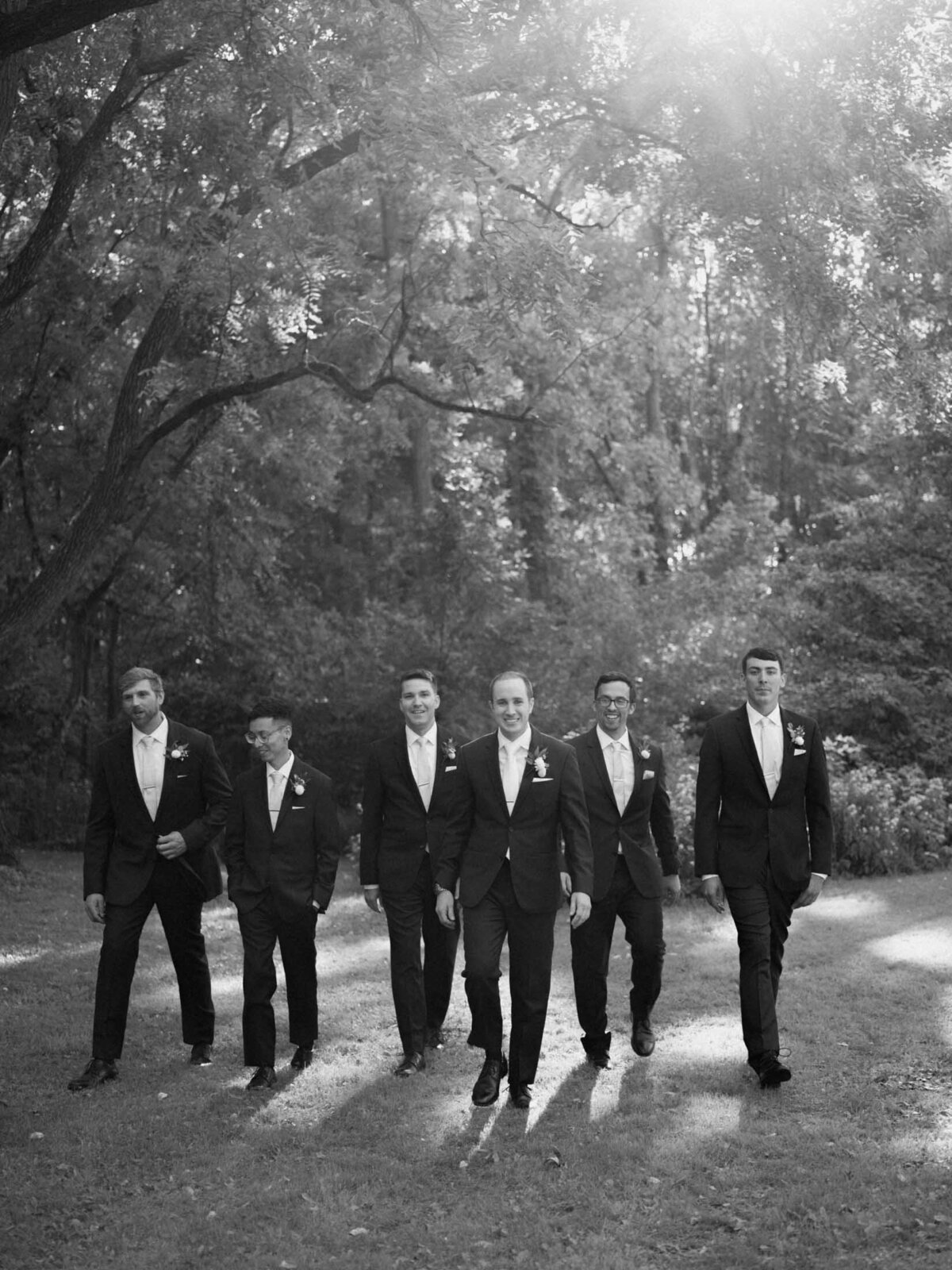 Candid moment of groom with groomsmen.