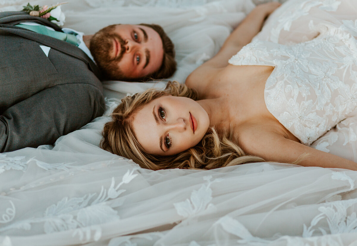 bride and groom laying down