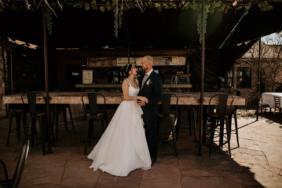 bride and groom standing together at a brewery in Santa Fe