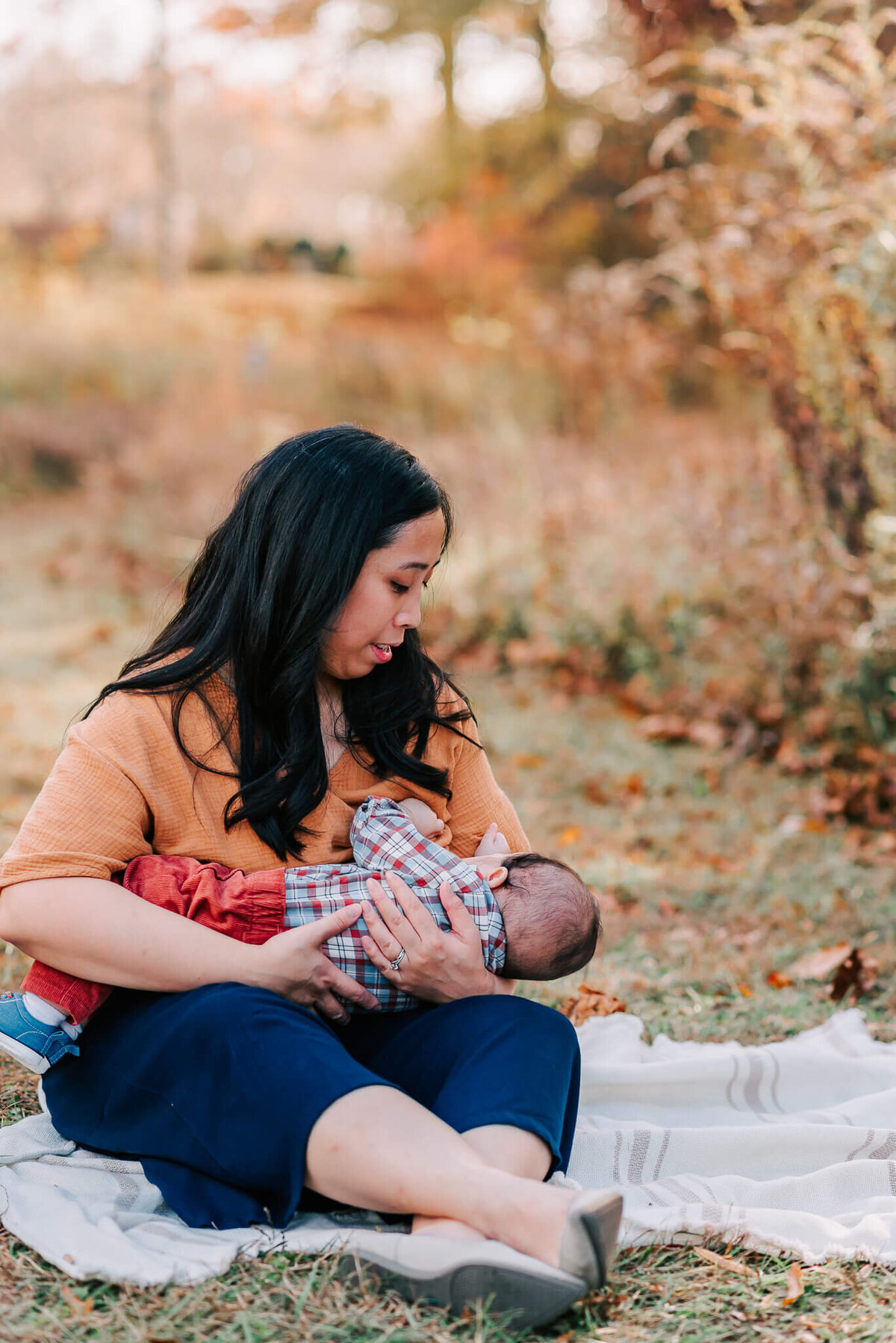 A woman breastfeeding her baby boy during her family session in Northern Virginia