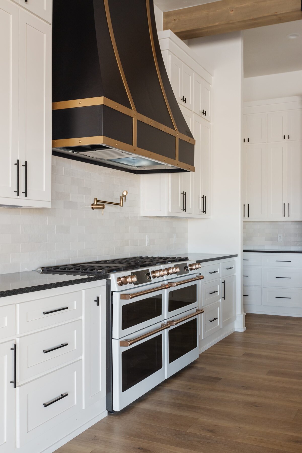 Marcie Meredith Texas based interior design photography. White kitchen stove black and gold.