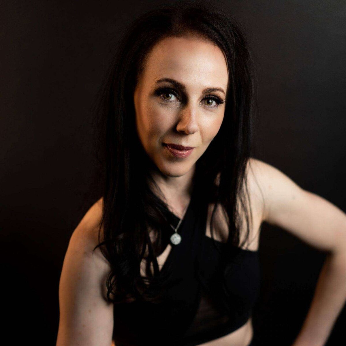 A woman poses in a sports bra during a headshot photoshoot near Vancouver