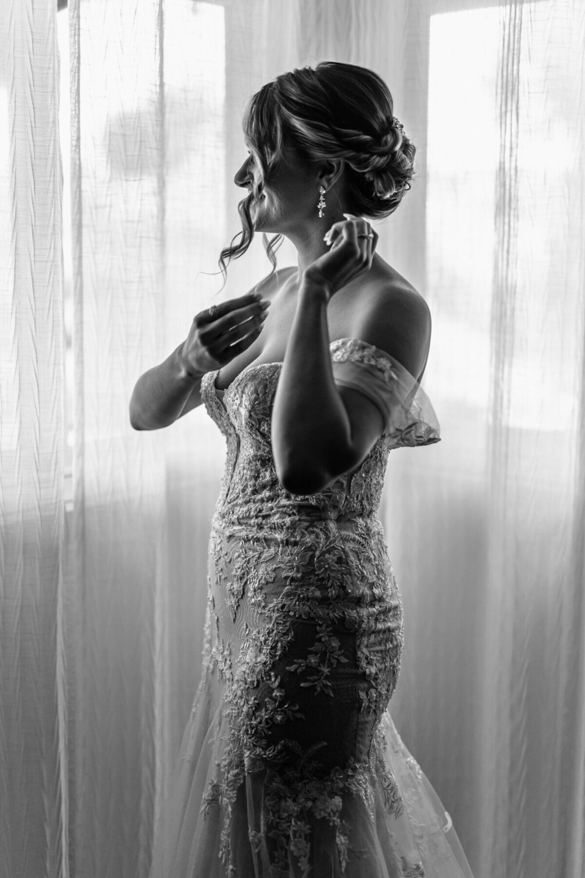Bride adjusting her hair while getting ready to walk down the isle.