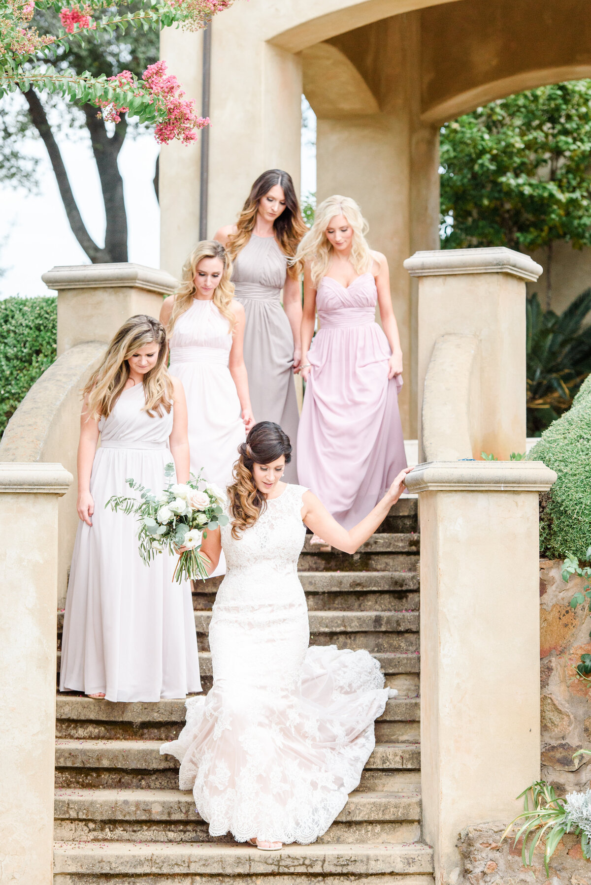bride and bridesmaids on staircase