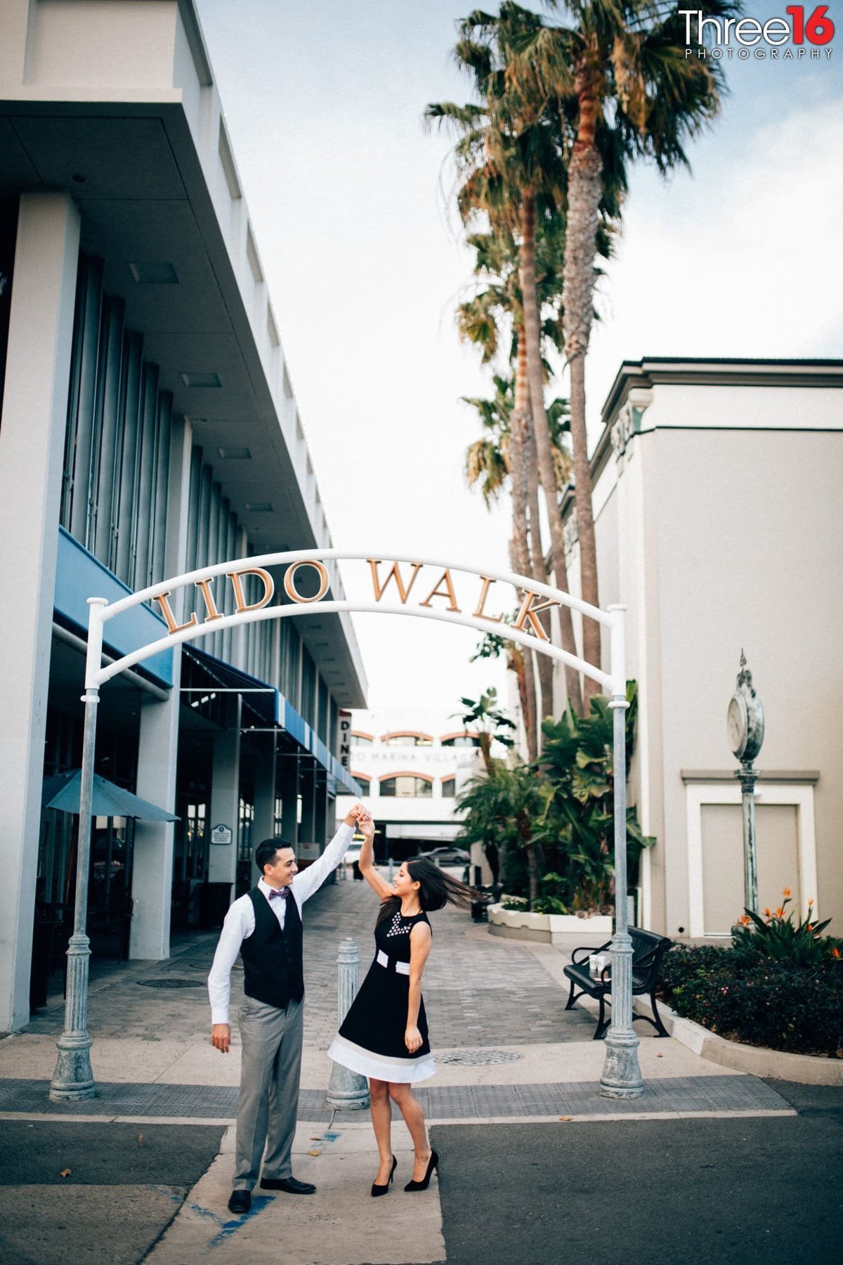 Groom to be twirls his Bride in the street in Newport Island