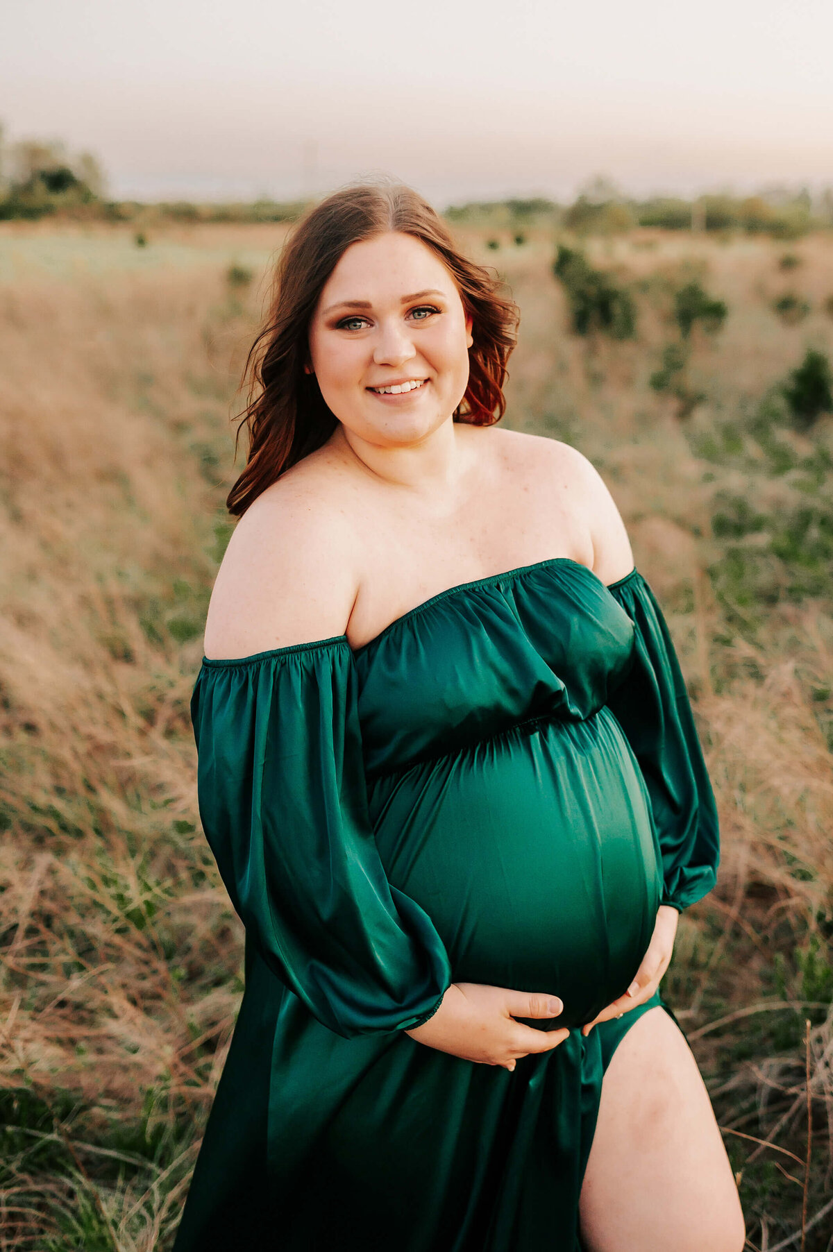 pregnant mom smiling and enjoying maternity photographer in Springfield MO