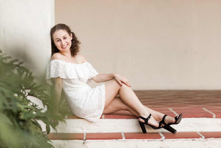 San Diego State Senior sitting on  steps