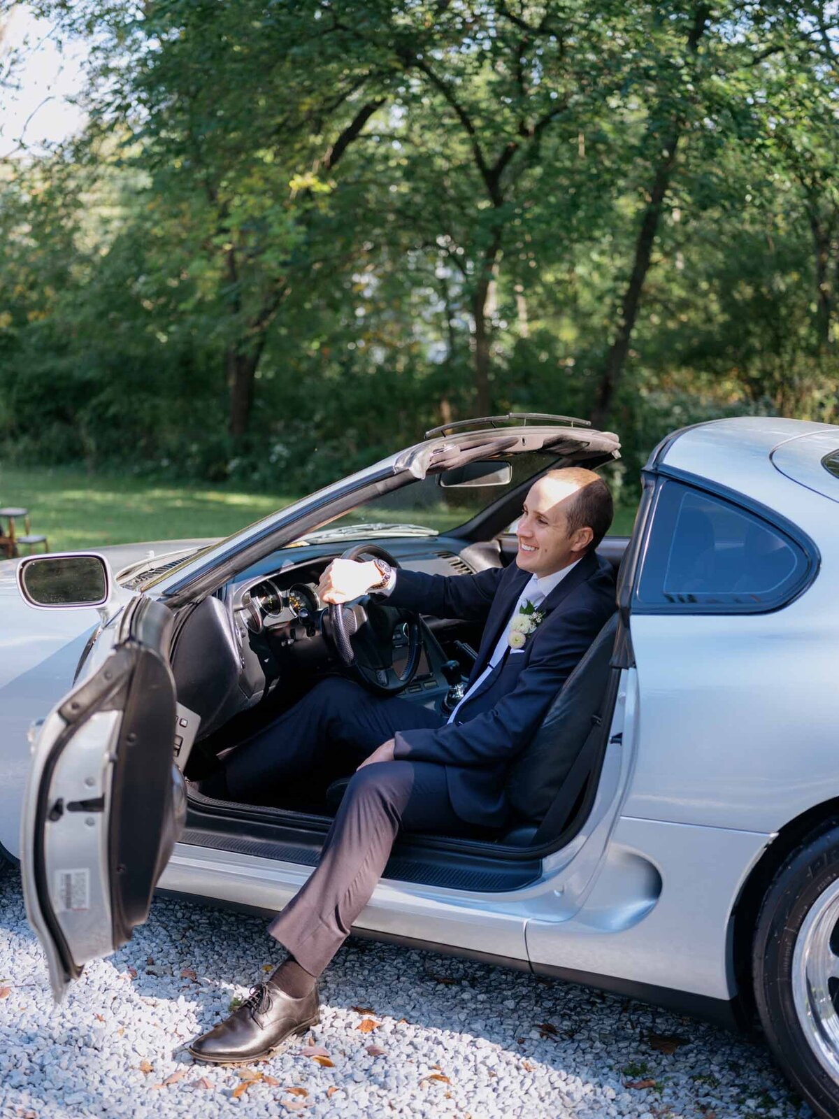 Groom in his sports car.