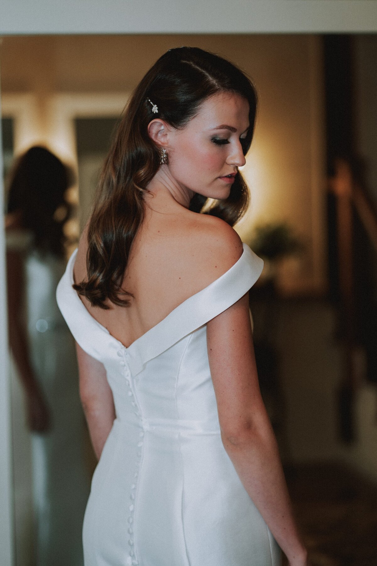 Bride shows off her off the shoulder wedding dress.