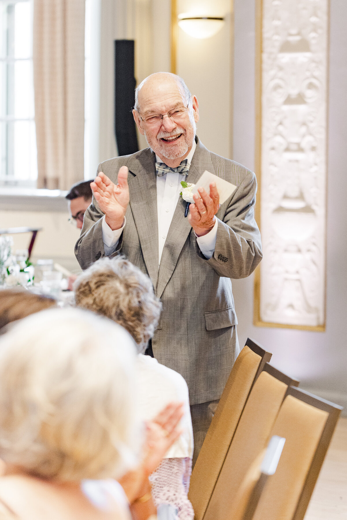 15_grandparent_smiling_clapping_during_speeches
