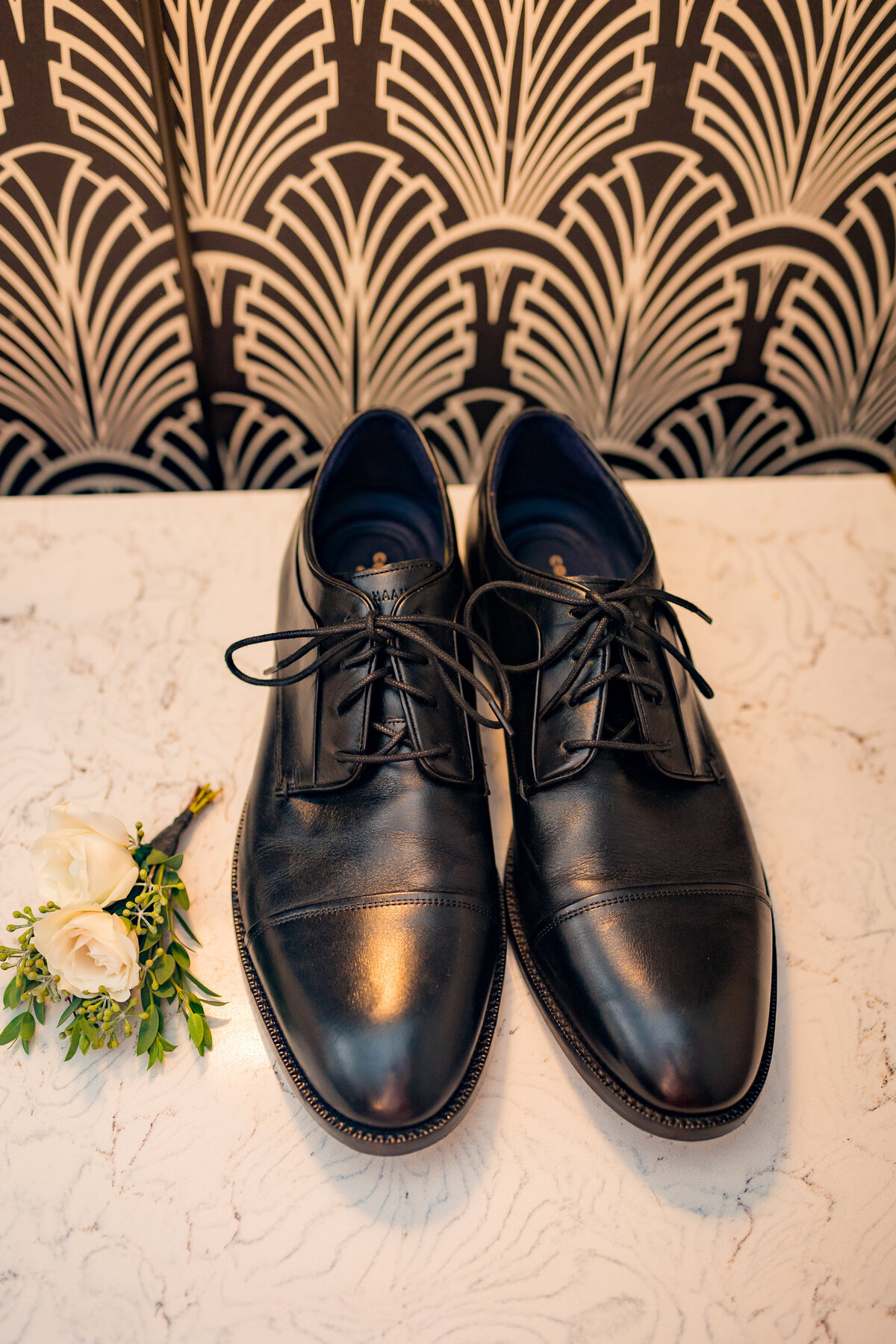 Grooms shoes and boutonniere