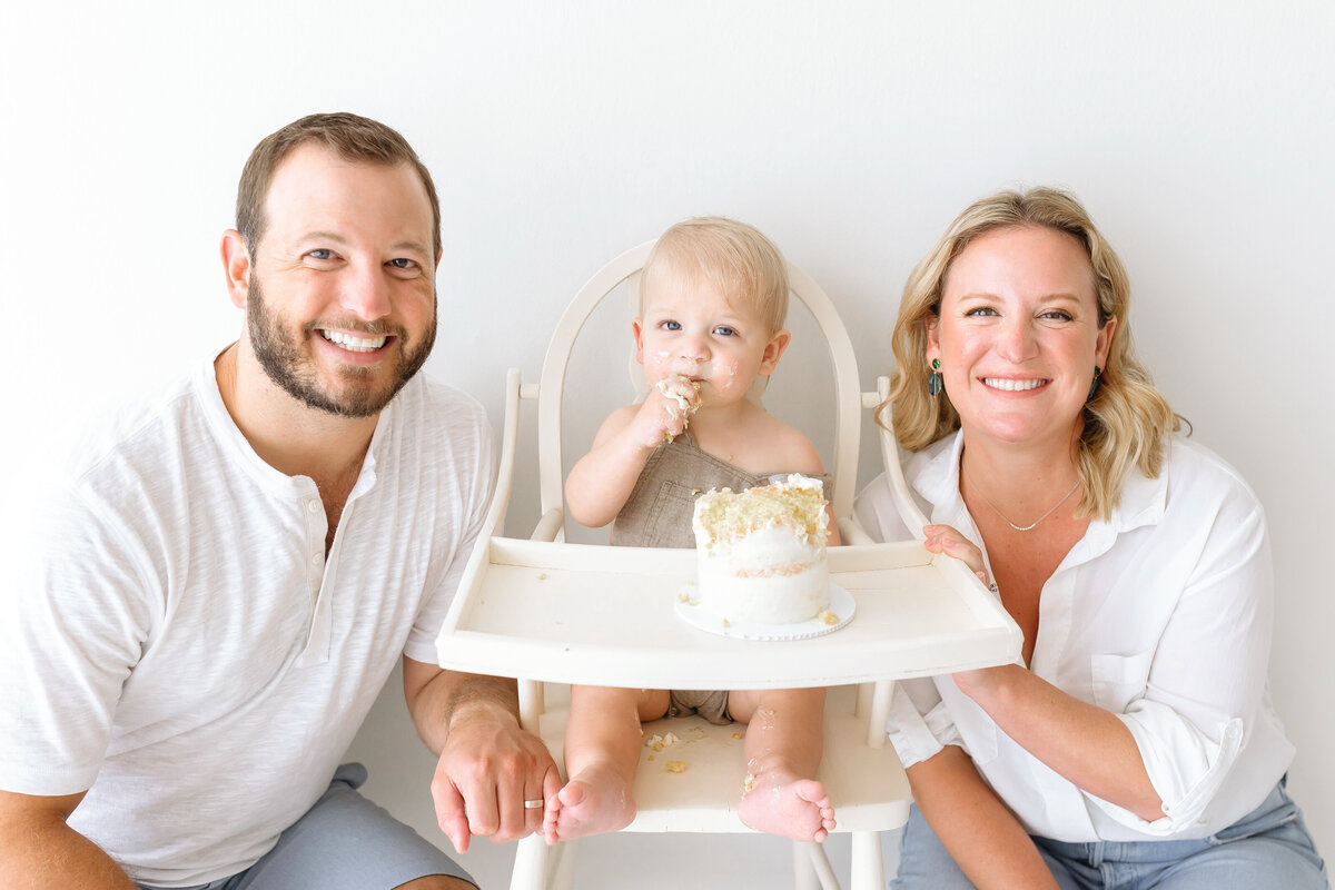 parents and toddler eating cake
