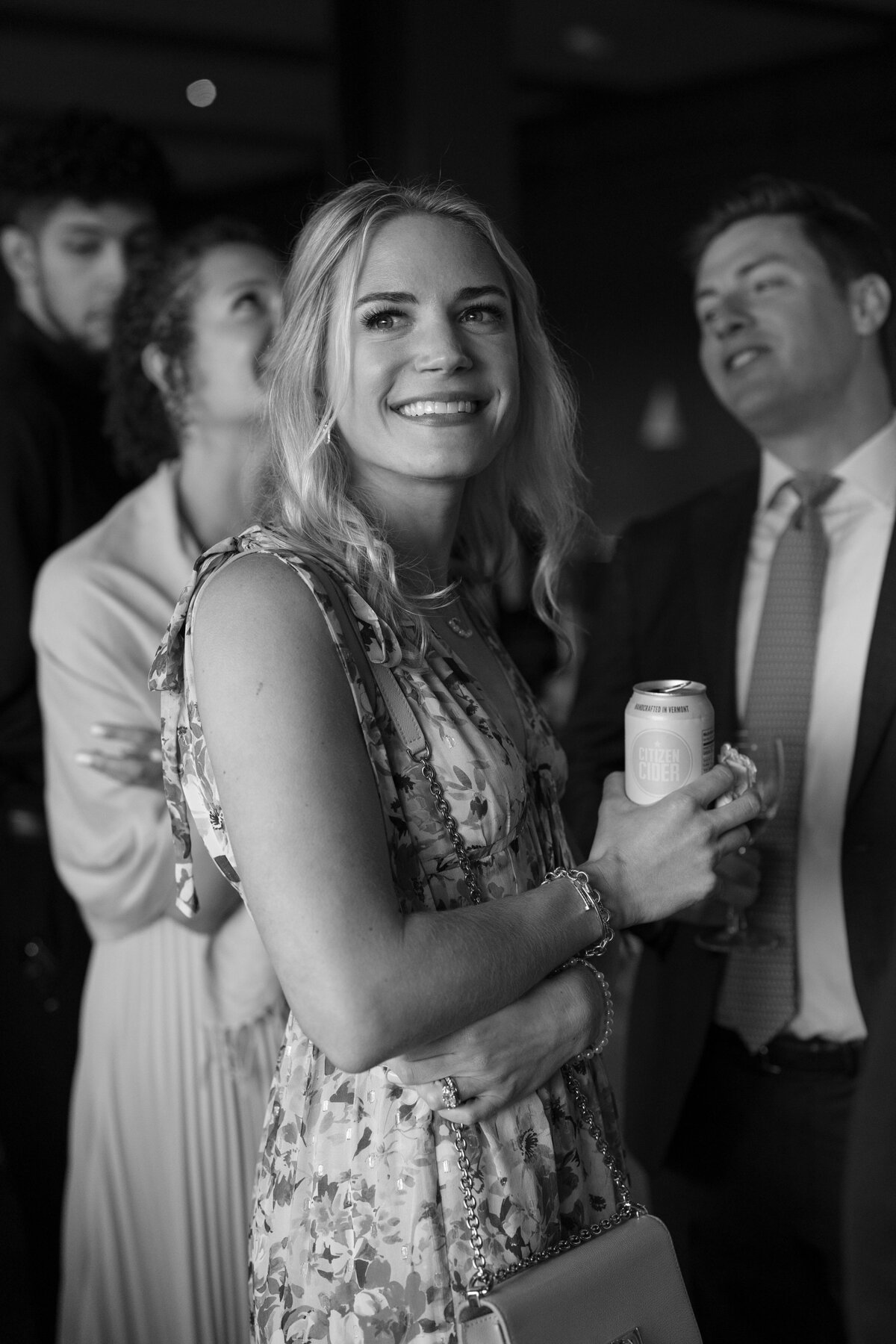 Wedding guest smiles towards camera of New Hampshire wedding.