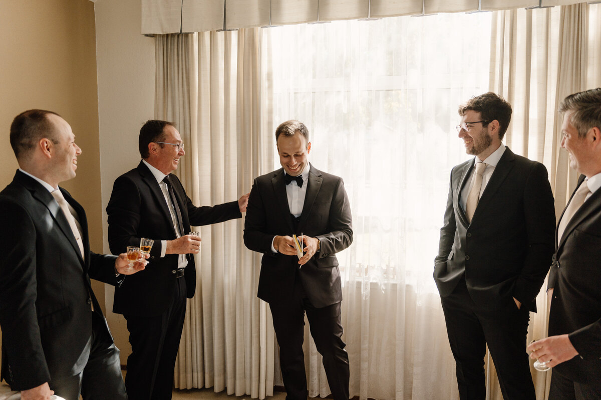 groomsmen congratulating groom on wedding day