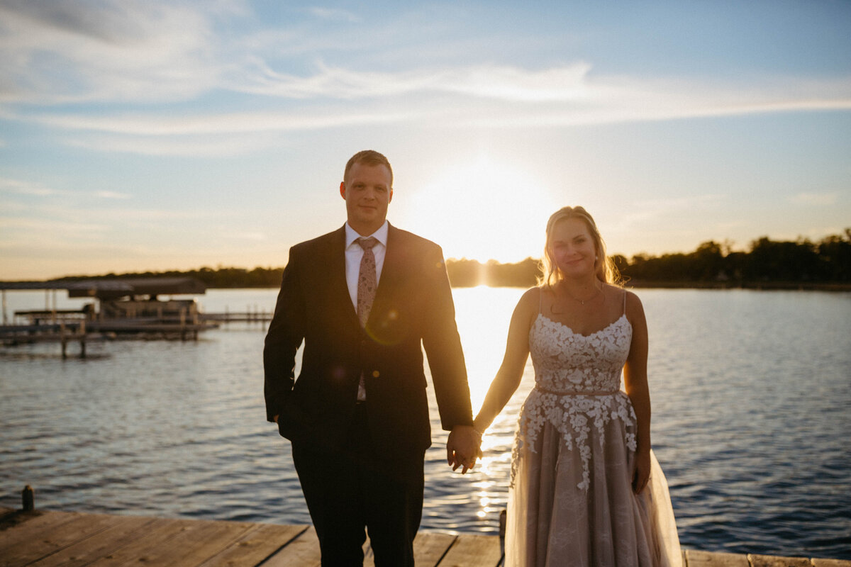 bride-and-groom-holding-hands-by-the-lake