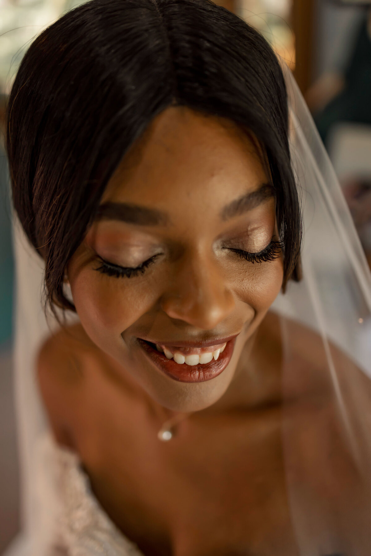 a bride has her makeup done for her wedding