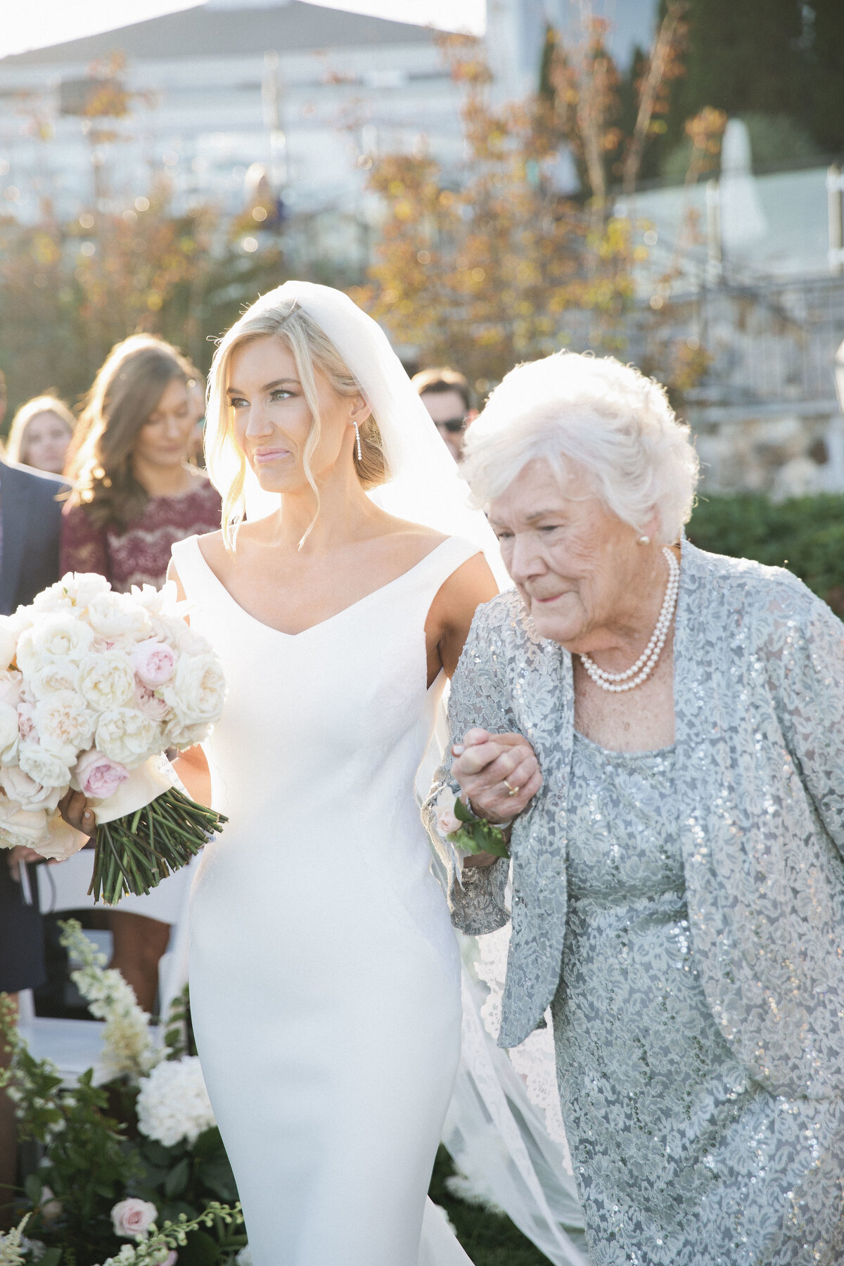 Whitney Bischoff and her Grandmother walking down the aisle together at Wequassett Resort