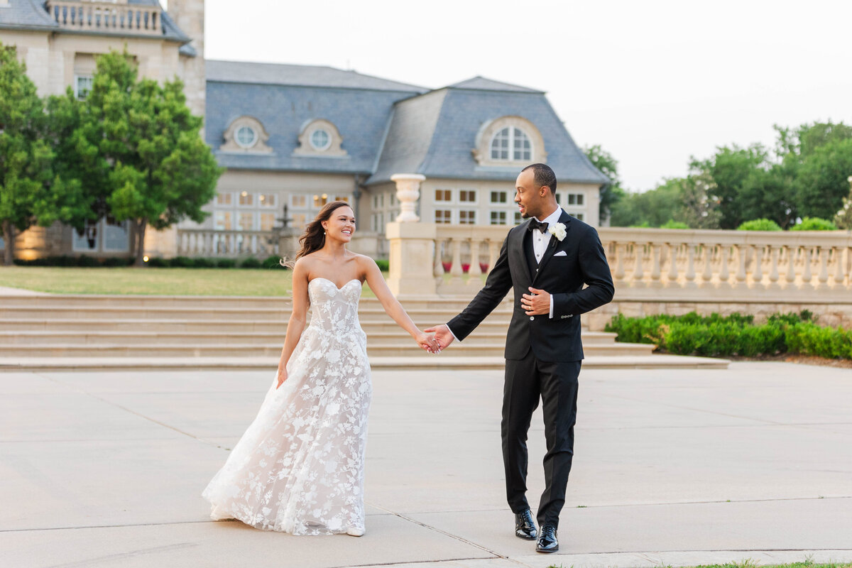 Quinn-andcouple-walking-hand--hand-in-hand-in-hand-in-fornt-of DFW-mansion