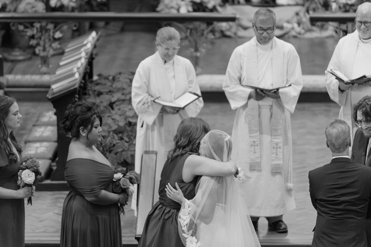Intimate moment between bride and mother of the bride during ceremony in Texas church wedding venue