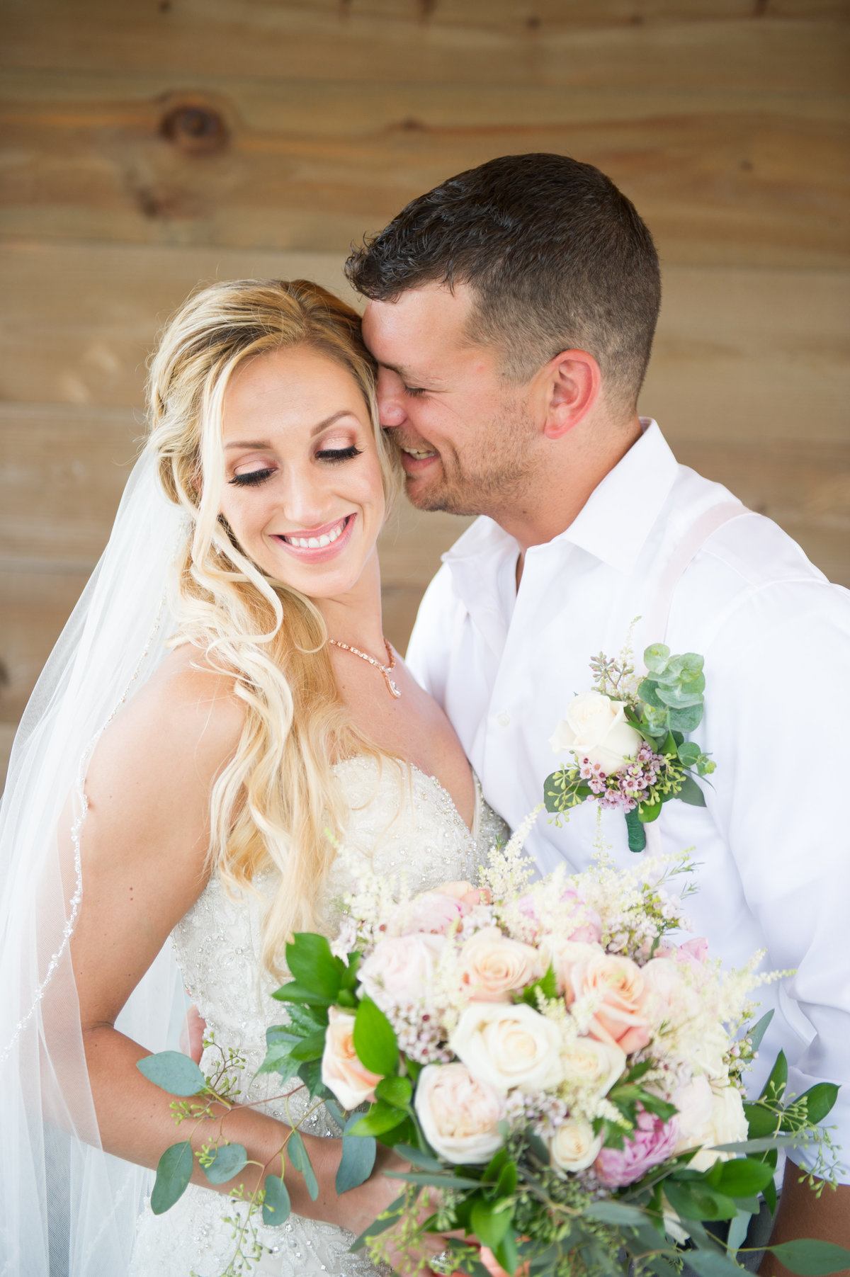 groom makes bride laugh with flowers