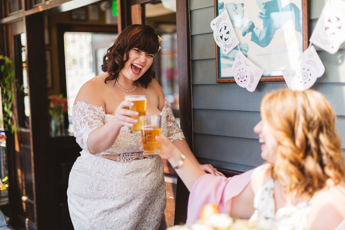 Bride in a pub raising a beer