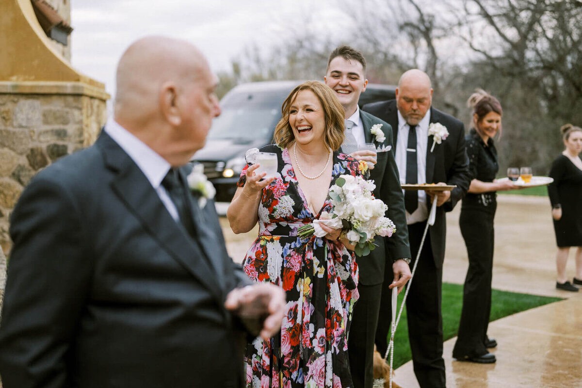 woman-holding-glass-while-laughing