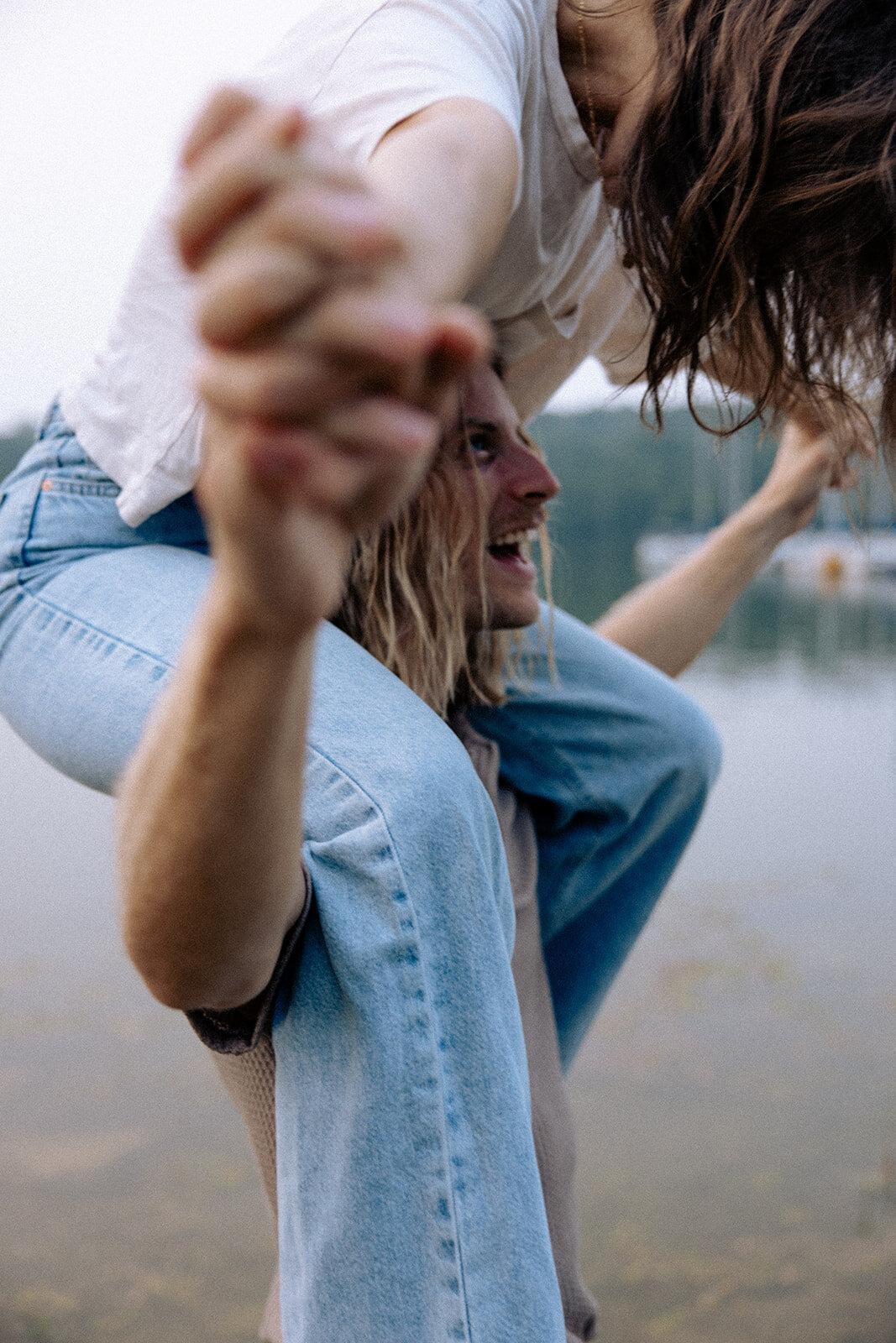 Couple laughs candidly together during documentary photography session.