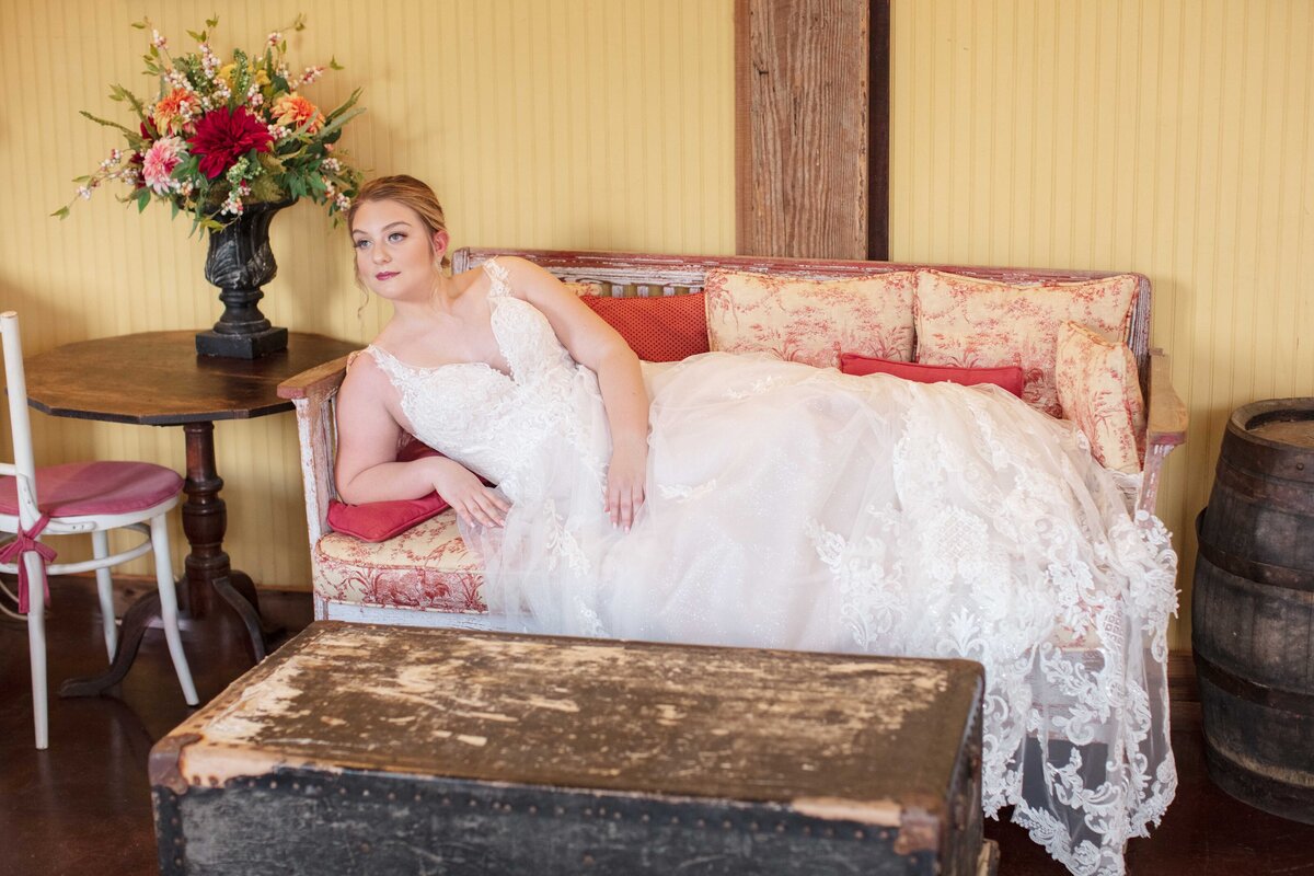 bride  on vintage couch wedding gown from Fiancee Bridal Boutique in Boerne by San Antonio wedding photographer Firefly Photography
