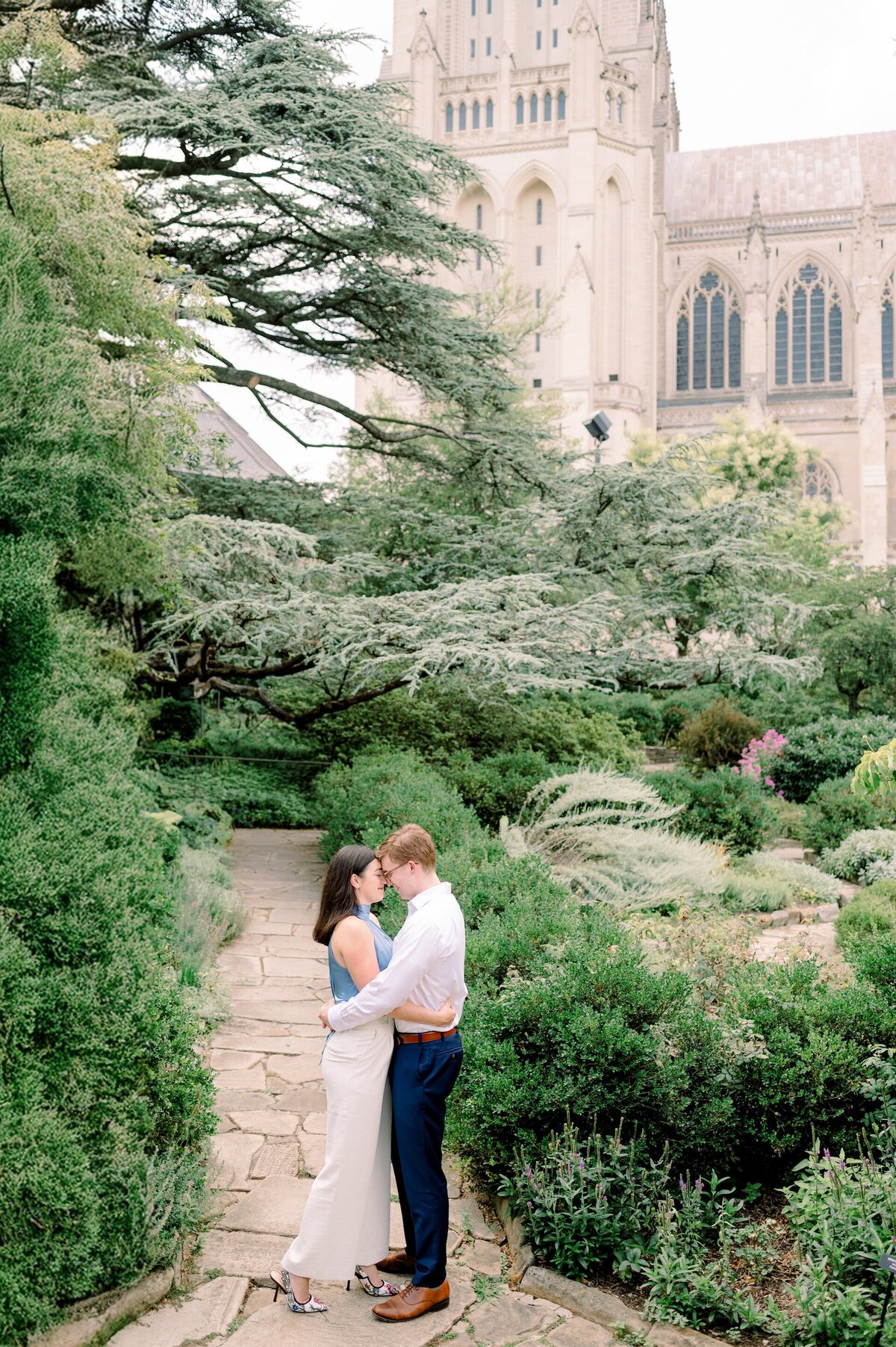 engaged couple embracing near the National Cathedral in Washington D.C.