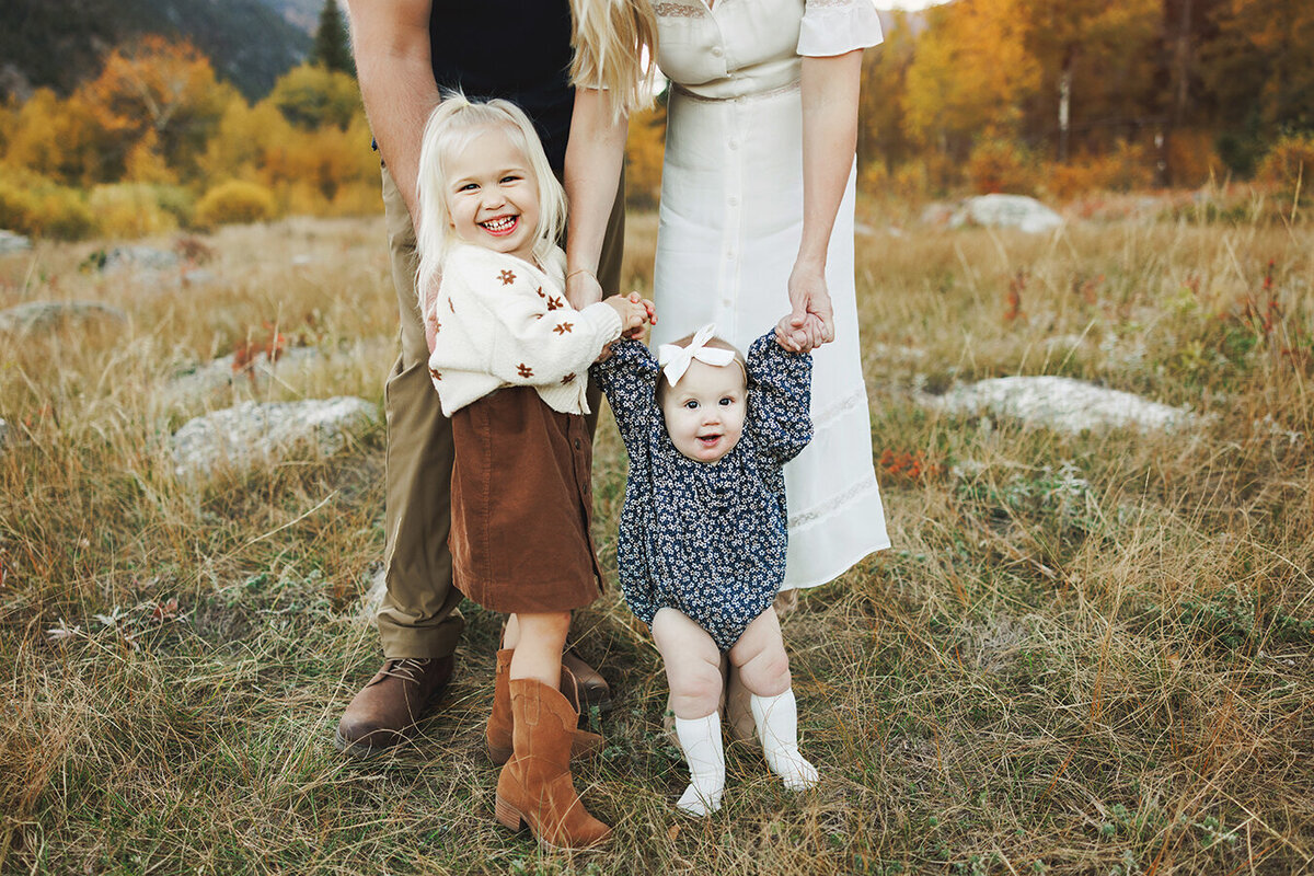 Cute family holding hands in Colorado mountains