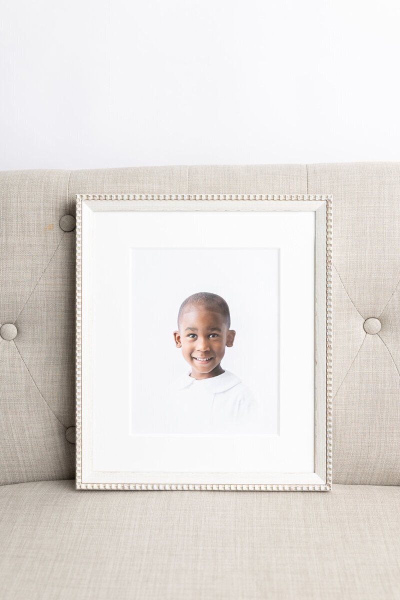 photography in Savannah GA of Framed heirloom child portrait on sofa