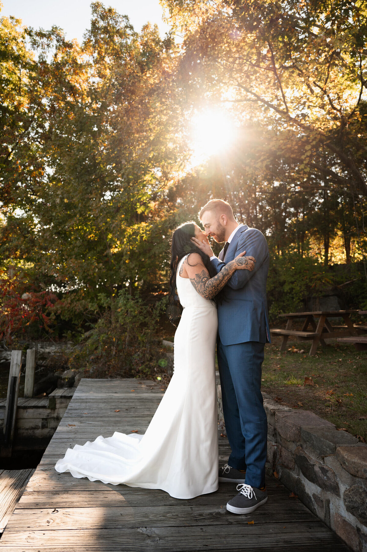 The bride and groom sharing a kiss on the shores of Lake George during their Adirondack Mountain wedding at the Sagamore Golf House.