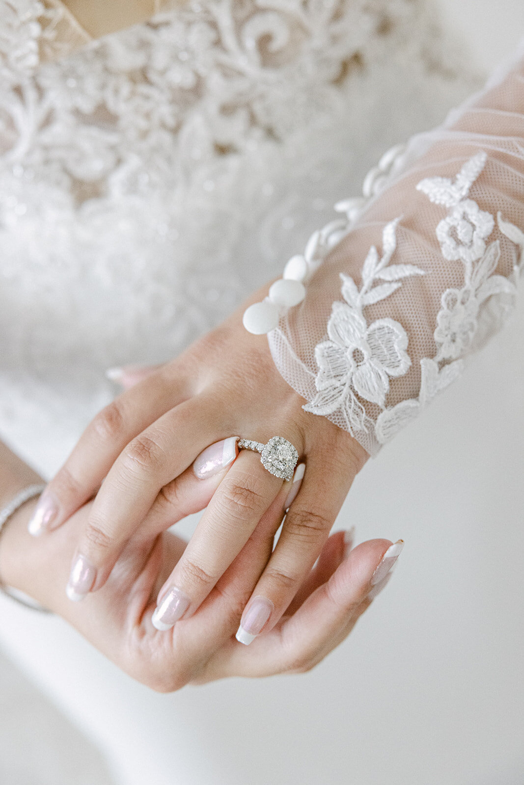 close up of a bride's hand with a  wedding ring on it