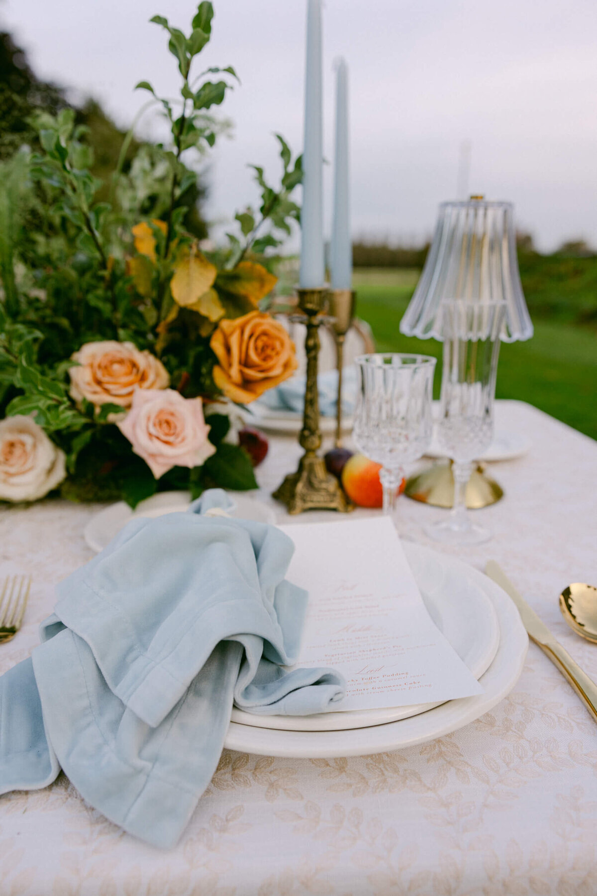 A wedding photo of the reception tables decorated in fine linens, candles & florals at Luttrellstown Castle