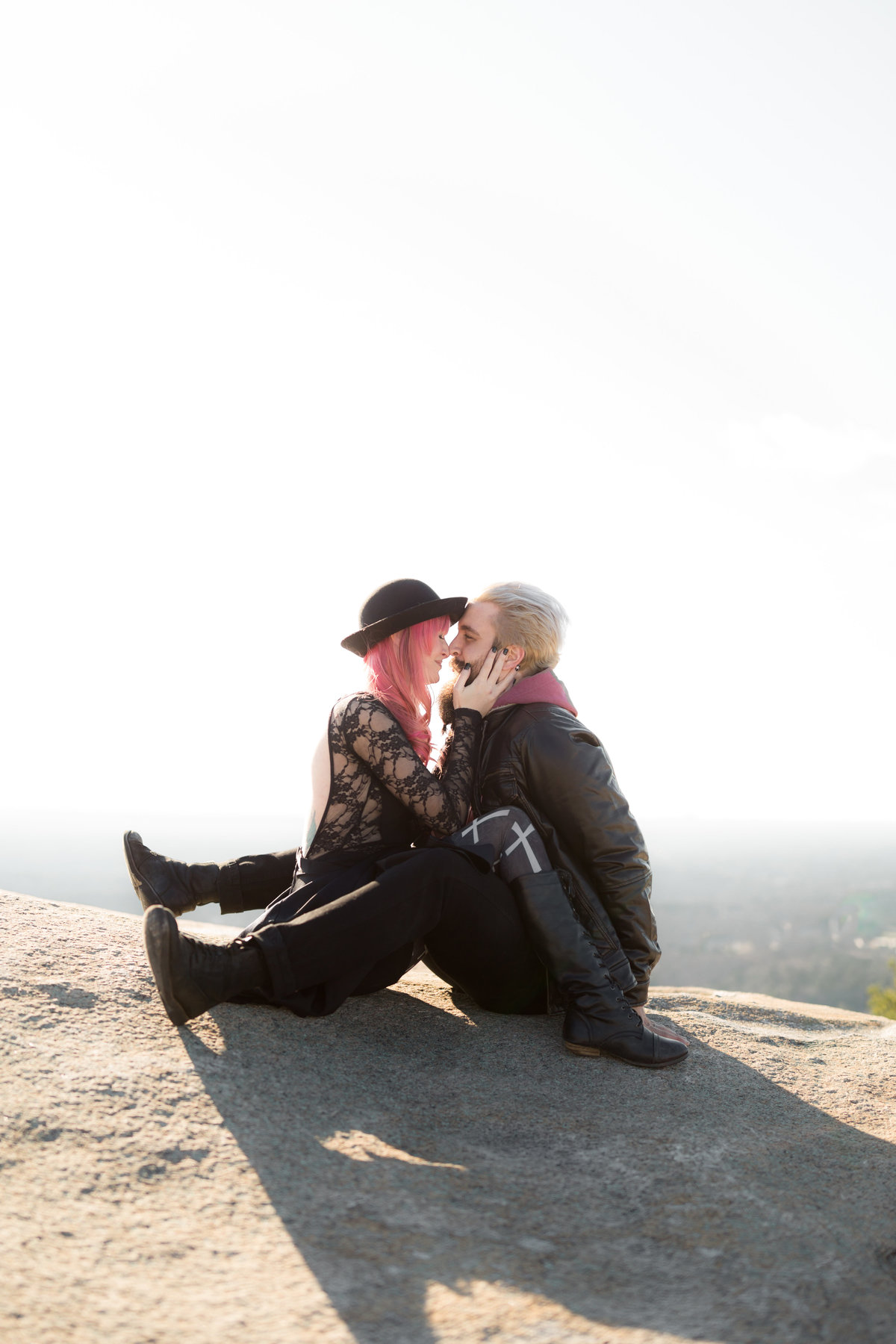 trendy married couple posing for Atlanta wedding photographer atop stone mountain