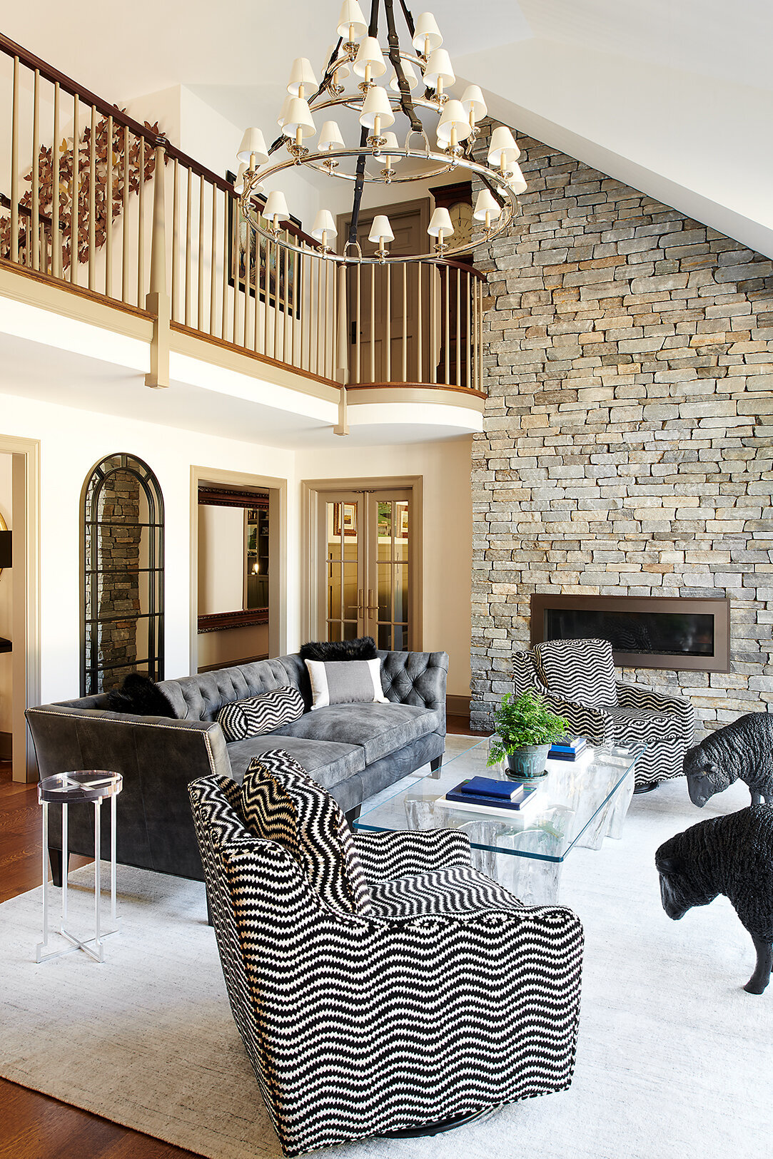 high ceiling living room with interior balcony railing