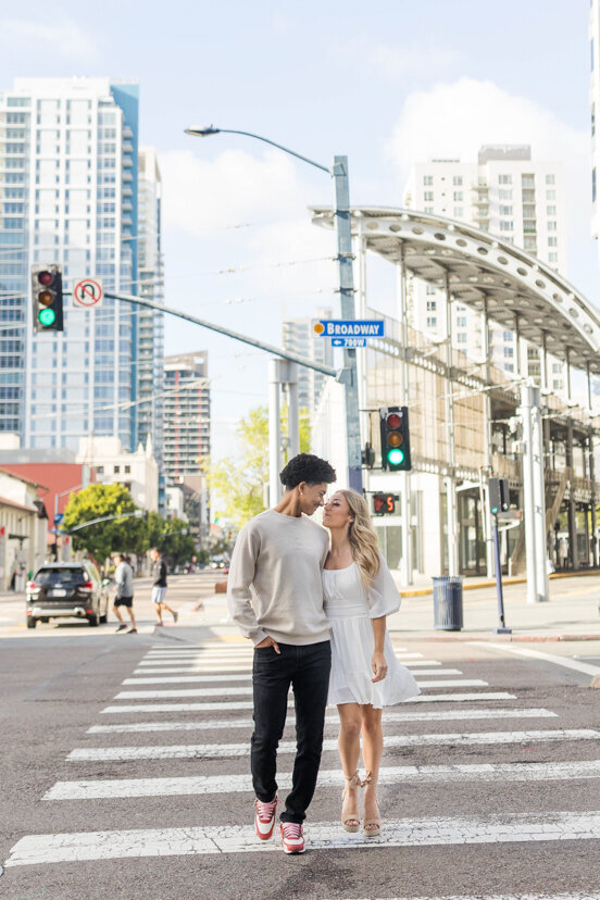 engaged-couple-crossing-crosswalk-downtown-san-diego
