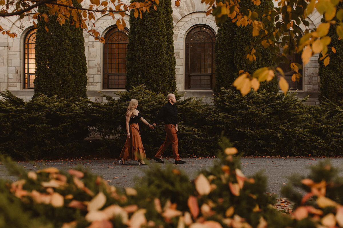 a couple walking along a road in fall 
