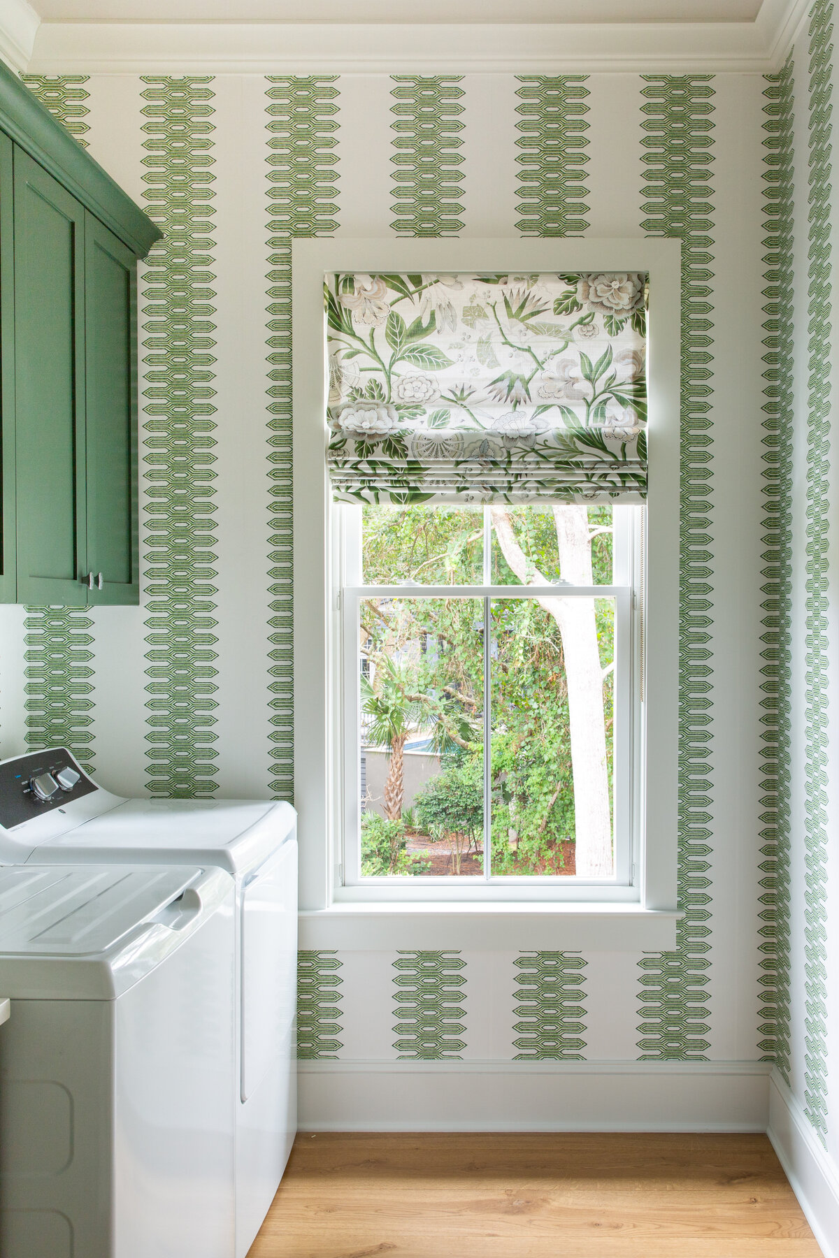 Charming window seat in Kiawah Island, SC, with patterned Roman shades and soft textures.