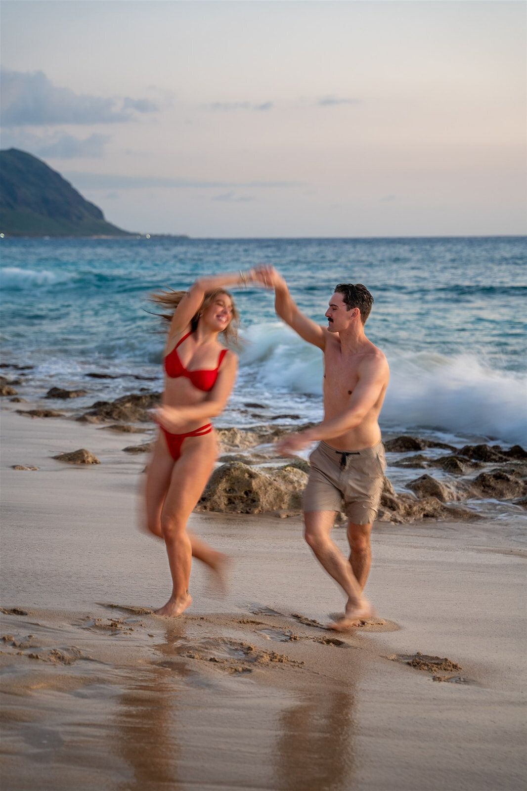 Couple dancing on the beach, taken by Hawaii engagement photographer