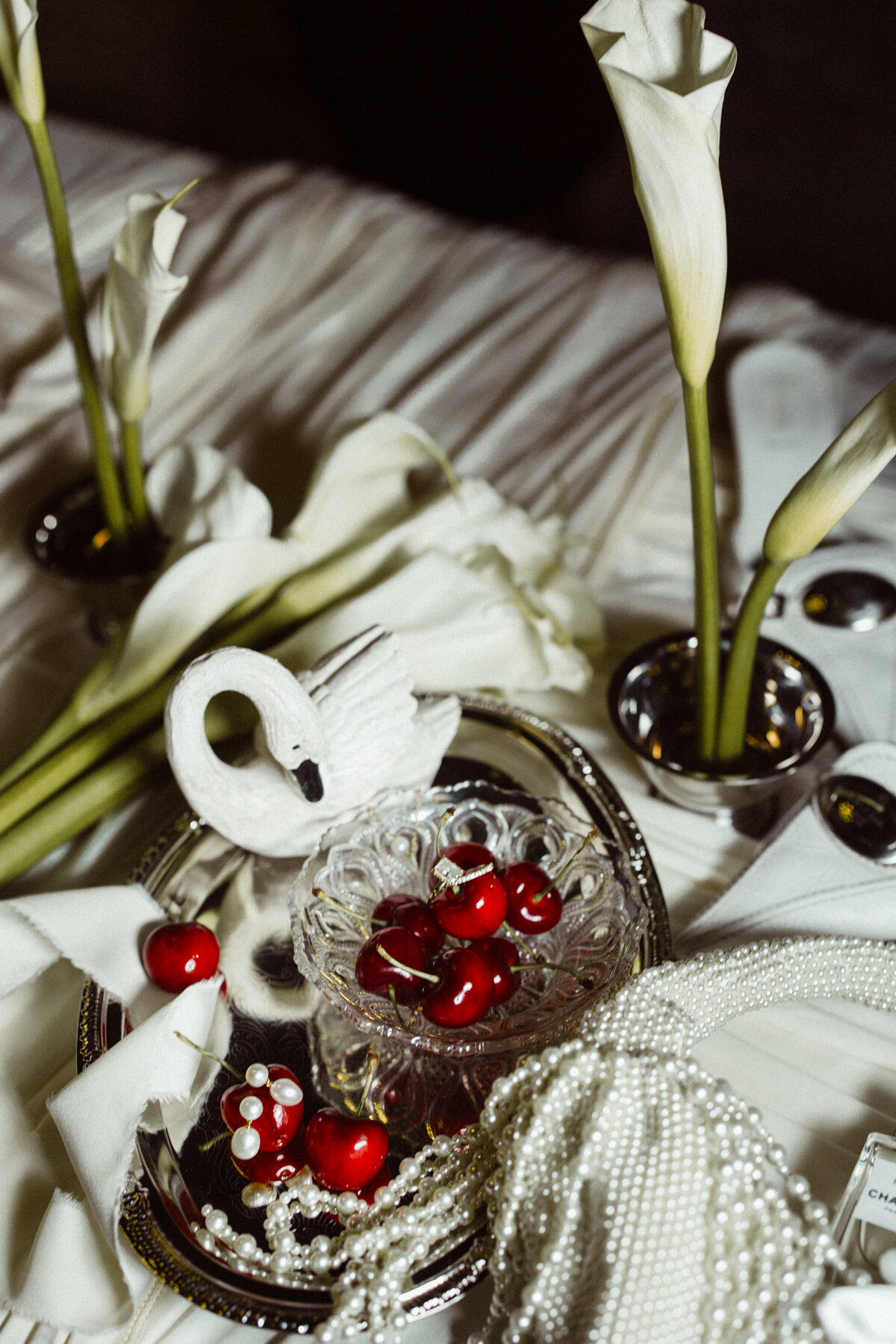 Swan and cherry wedding details along with calla lilies at a wedding photographed by Clewell Photography