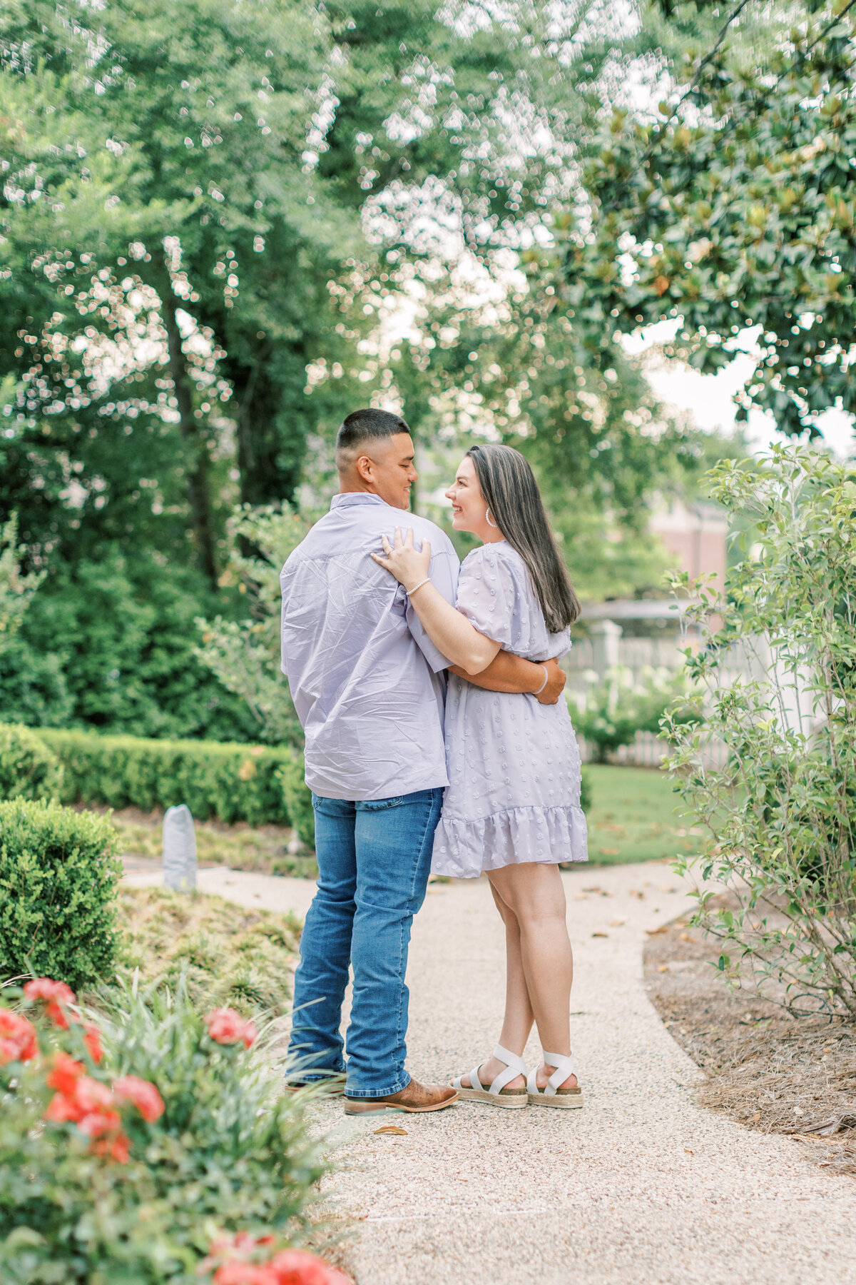 A couple stands facing backward with their arms around each other in Hattiesburg.